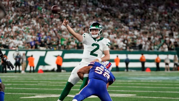 New York Jets quarterback Zach Wilson (2) throws the ball as Buffalo Bills linebacker Matt Milano (58) tackles him during the first half of the home opener at MetLife Stadium on Monday, Sept. 11, 2023, in East Rutherford.