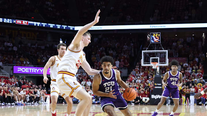 Feb 8, 2025; Ames, Iowa, USA; Iowa State Cyclones center JT Rock (30) defends TCU Horned Frogs guard Noah Reynolds (21) during the second half at James H. Hilton Coliseum. Mandatory Credit: Reese Strickland-Imagn Images