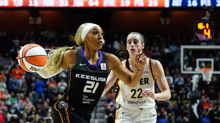 May 14, 2024; Uncasville, Connecticut, USA; Connecticut Sun guard DiJonai Carrington (21) drives the ball against Indiana Fever guard Caitlin Clark (22) in the second half at Mohegan Sun Arena. May 14, 2024; Uncasville, Connecticut, USA; Connecticut Sun guard DiJonai Carrington (21) drives the ball against Indiana Fever guard Caitlin Clark (22) in the second half at Mohegan Sun Arena.