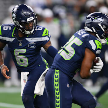 Aug 7, 2025; Seattle, Washington, USA; Seattle Seahawks quarterback Jalen Milroe (6) hands the ball off to running back Anthony Tyus III (35) during the second half at Lumen Field.