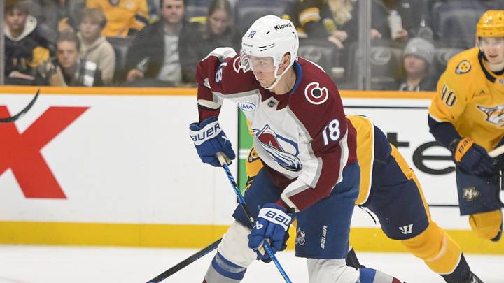 Dec 9, 2025; Nashville, Tennessee, USA;  Colorado Avalanche center Jack Drury (18) takes a shot on goal against the Nashville Predators during the third period at Bridgestone Arena. Mandatory Credit: Steve Roberts-Imagn Images