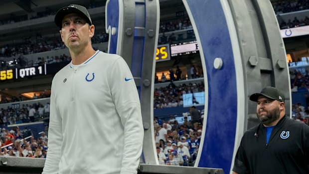 Colts head coach Shane Steichen (white shirt) walks out onto the field to start the game against the Broncos.