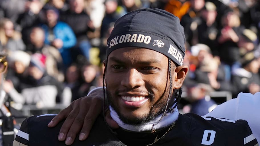Nov 29, 2024; Boulder, Colorado, USA; Colorado Buffaloes safety Shilo Sanders (21) and head coach Deion Sanders and quarterback Shedeur Sanders (2) and social media producer Deion Sanders Jr. following the win against the Oklahoma State Cowboys at Folsom Field. Mandatory Credit: Ron Chenoy-Imagn Images | Ron Chenoy-Imagn Images