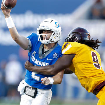 Memphis' Seth Henigan (2) throws the ball as Bethune-Cookman   s Eddie Walls III (9) tries to tackle him during the game between the University of Memphis and Bethune-Cookman University in Memphis, Tenn., on Saturday, September 2, 2023.