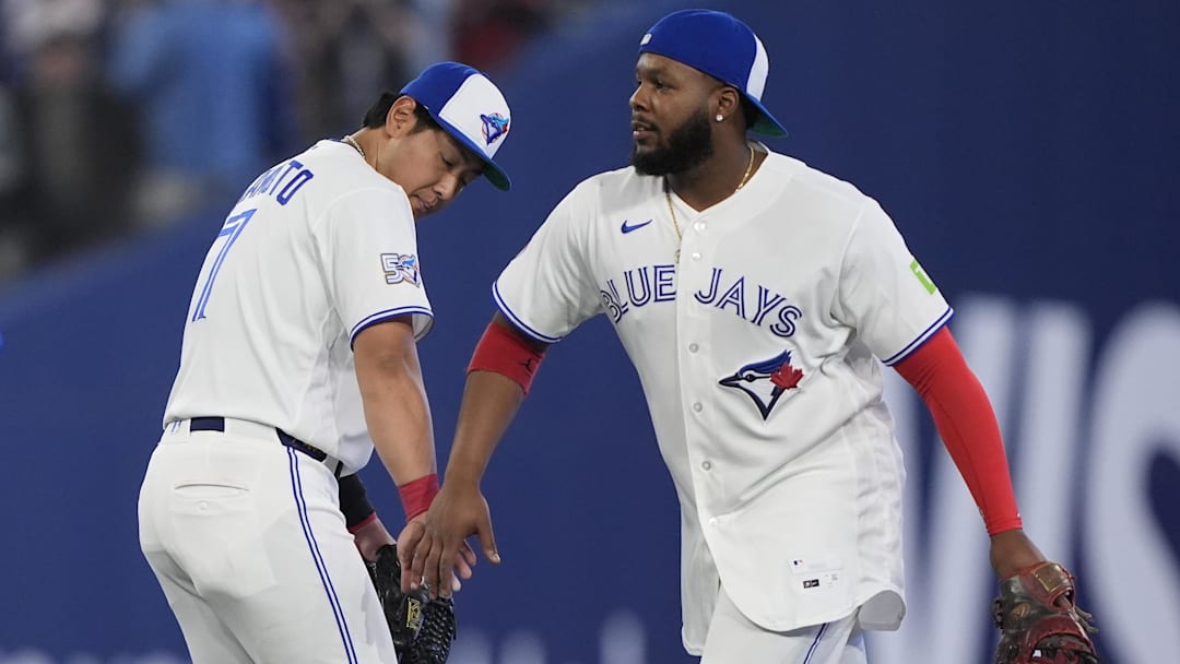 Mar 29, 2026; Toronto, Ontario, CAN; Toronto Blue Jays third baseman Kazuma Okamoto (7) and first baseman Vladimir Guerrero Jr. (27) celebrate a win over the Athletics at Rogers Centre. Mandatory Credit: John E. Sokolowski-Imagn Images