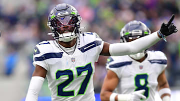 Dec 4, 2022; Inglewood, California, USA; Seattle Seahawks cornerback Tariq Woolen (27) celebrates after intercepting a pass intended for Los Angeles Rams running back Kyren Williams (23) during the first half at SoFi Stadium. Mandatory Credit: Gary A. Vasquez-Imagn Images