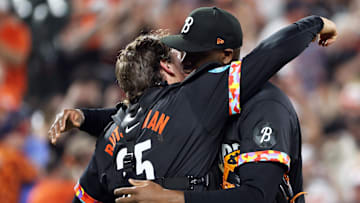 May 2, 2025; Baltimore, Maryland, USA; Baltimore Orioles pitcher Felix Bautista (74) and Baltimore Orioles catcher Adley Rutschman (35) hug after a game against the Kansas City Royals at Oriole Park at Camden Yards. Mandatory Credit: Daniel Kucin Jr.-Imagn Images