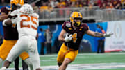 Arizona State running back Cam Skattebo (4) runs against Texas defensive back Jelani McDonald (25) during the third quarter of the Chick-fil-A Peach Bowl in Atlanta on Jan. 1, 2025.
