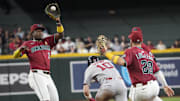 Boston Red Sox infielder Trevor Story (10) ducks under a tag by Arizona Diamondbacks shortstop Geraldo Perdomo (2) during a rundown during the seventh inning at Chase Field on Sept. 7, 2025. Story was safe at second.