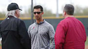Diamondbacks General Manager Mike Hazen (center) talks with Managing General Partner Ken Kendrick (left) and President and CEO Derrick Hall at spring training in 2018.

Diamondbacks Spring Training