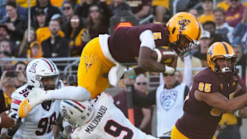Arizona State quarterback Jaden Rashada is tackled by Arizona safety Gunner Maldonado (9) during the third quarter at Mountain America Stadium on Nov 25, 2023.