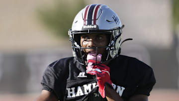 Defensive back/wide receiver Dajon Hinton puts his mouthguard in during practice at Hamilton HS football field on Aug 26, 2024, in Chandler.