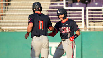 Arizona’s Aaron Walton (11) and Garen Caulfield (1) celebrate after both scoring against Grand Canyon during the first inning at GCU Ballpark in Phoenix, on April 1, 2025.