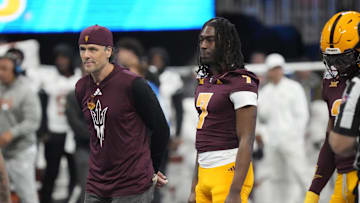 Former Arizona State quarterback Jake Plummer walks out with players for the coin toss against Texas in the Chick-fil-A Peach Bowl in Atlanta on Jan. 1, 2025.