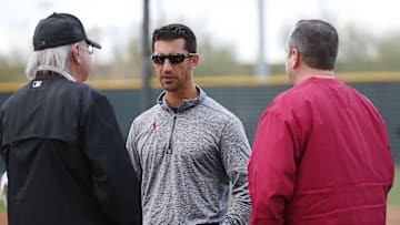 Diamondbacks General Manager Mike Hazen (center) talks with Managing General Partner Ken Kendrick (left) and President and CEO Derrick Hall at spring training in 2018.

Diamondbacks Spring Training