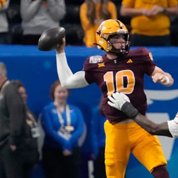 Arizona State quarterback Sam Leavitt (10) throws under pressure by Texas linebacker Colin Simmons (11) during the first quarter of the Chick-fil-A Peach Bowl in Atlanta on Wednesday, Jan. 1, 2025.