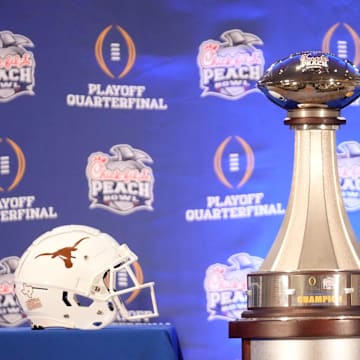 The Peach Bowl trophy on display before a joint news conference with Texas head coach Steve Sarkisian and Arizona State head coach Kenny Dillingham.