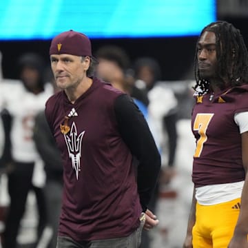 Former Arizona State quarterback Jake Plummer walks out with players for the coin toss against Texas in the Chick-fil-A Peach Bowl in Atlanta on Jan. 1, 2025.
