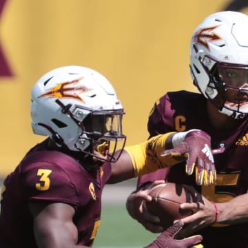 ASU QB Jayden Daniels (5) hands the ball off to RB Rachaad White (3) during spring football practice in Tempe, Ariz. March 28, 2021.

Asu Spring Football