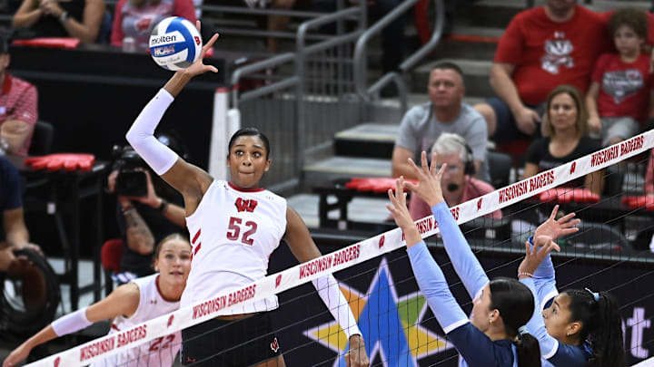 Wisconsin middle blocker Carter Booth (52) slams the ball past the Marquette block in a match Tuesday, September 17, 2024, at the Kohl Center in Madison, Wisconsin.