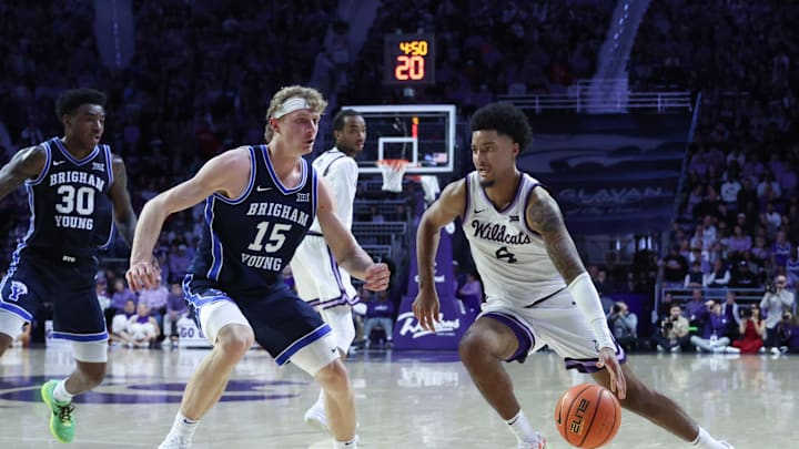 Kansas State Wildcats guard P.J. Haggerty dribbles against Brigham Young Cougars guard Richie Saunders 