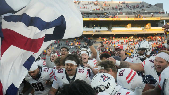 Nov 25, 2023; Tempe, Arizona, USA; Arizona players celebrate after winning the Territorial Cup against Arizona State 59-23 at Mountain America Stadium. Mandatory Credit: Michael Chow-Arizona Republic