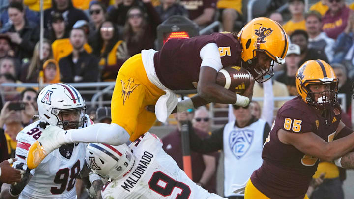 Arizona State quarterback Jaden Rashada is tackled by Arizona safety Gunner Maldonado (9) during the third quarter at Mountain America Stadium on Nov 25, 2023.