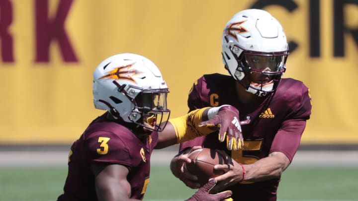 ASU QB Jayden Daniels (5) hands the ball off to RB Rachaad White (3) during spring football practice in Tempe, Ariz. March 28, 2021.

Asu Spring Football