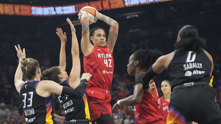 Atlanta Dream center Brittney Griner (42) passes the ball while defended by Phoenix Mercury forward Kathryn Westbeld (24) and guard Sami Whitcomb (33) during the first quarter at PHX Arena Jul 23, 2025.