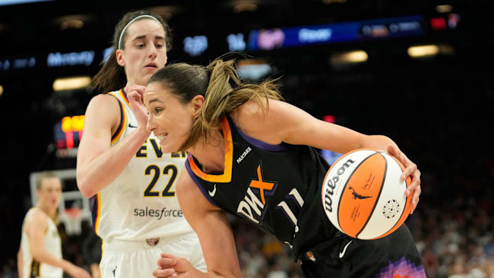 Phoenix Mercury guard Rebecca Allen (11) drives past Indiana Fever guard Caitlin Clark (22) during the first quarter at Footprint Center on June 30, 2024, in Phoenix.