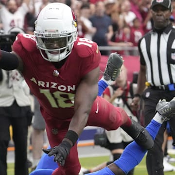 Arizona Cardinals wide receiver Marvin Harrison Jr. (18) reaches the ball for a touchdown against Los Angeles Rams safety Kamren Curl (3) during the first quarter at State Farm Stadium.