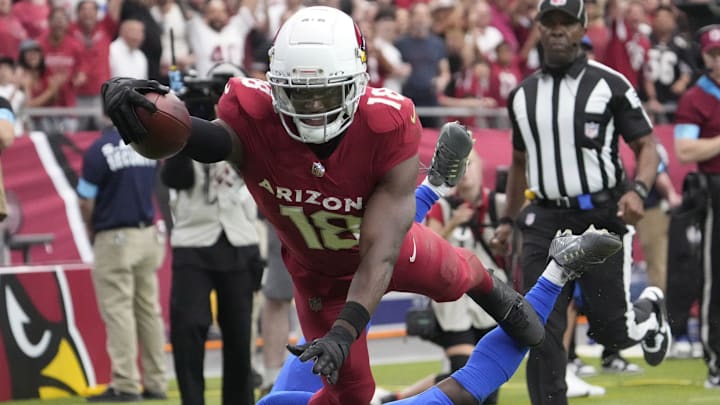 Arizona Cardinals wide receiver Marvin Harrison Jr. (18) reaches the ball for a touchdown against Los Angeles Rams safety Kamren Curl (3) during the first quarter at State Farm Stadium.