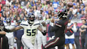 Arizona Cardinals quarterback Kyler Murray (1) throws while pressured by Seattle Seahawks defensive end Dre'Mont Jones (55) during the first quarter at State Farm Stadium in Glendale on Dec. 8, 2024.