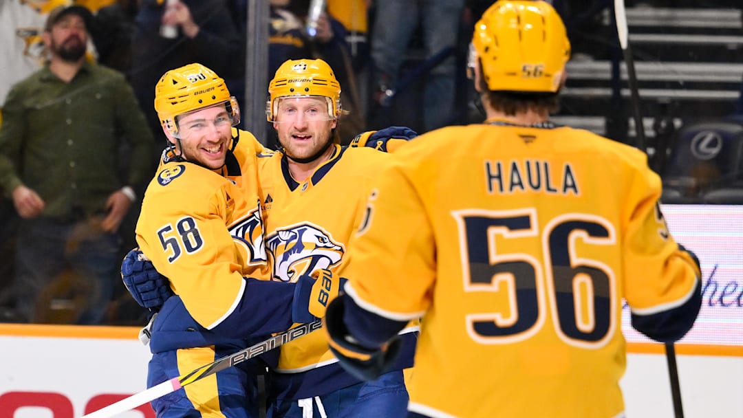 Jan 13, 2026; Nashville, Tennessee, USA;  Nashville Predators center Steven Stamkos (91) celebrates his goal with left wing Michael Bunting (58) and left wing Erik Haula (56) against the Edmonton Oilers during the first period at Bridgestone Arena. Mandatory Credit: Steve Roberts-Imagn Images