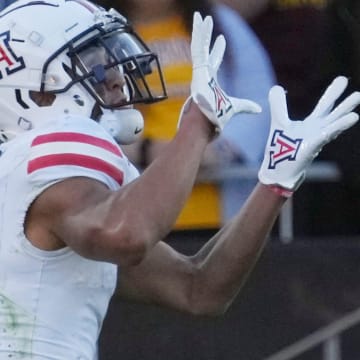 Arizona wide receiver Tetairoa McMillan (4) catches a touchdown pass against Arizona State during the third quarter at Mountain America Stadium in Tempe on Nov. 25, 2023.