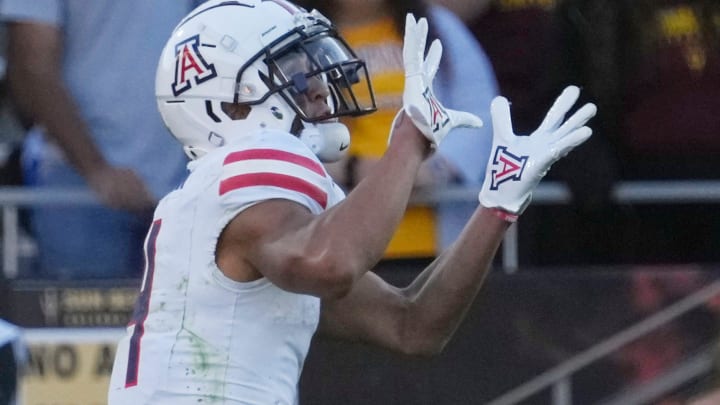 Arizona wide receiver Tetairoa McMillan (4) catches a touchdown pass against Arizona State during the third quarter at Mountain America Stadium in Tempe on Nov. 25, 2023.