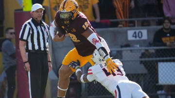Arizona State tight end Jalin Conyers (12) is brought down by Arizona safety Dalton Johnson (43) during the second quarter at Mountain America Stadium in Tempe on Nov. 25, 2023.