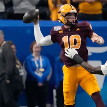 Arizona State quarterback Sam Leavitt (10) throws under pressure by Texas linebacker Colin Simmons (11) during the first quarter of the Chick-fil-A Peach Bowl in Atlanta on Wednesday, Jan. 1, 2025.