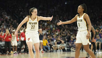 Jun 30, 2024; Phoenix, Ariz., U.S.; Indiana Fever guard Caitlin Clark (22) slaps hands with guard Kelsey Mitchell (0) during the third quarter against the Phoenix Mercury at Footprint Center. Mandatory Credit: Michael Chow-Arizona Republic