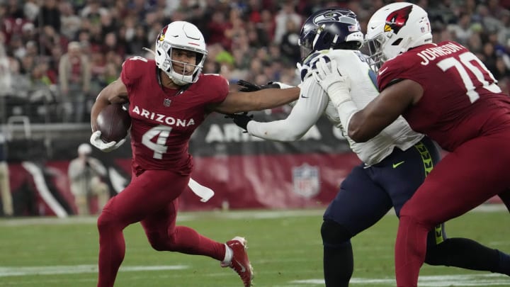 Arizona Cardinals wide receiver Rondale Moore (4) breaks away from Seattle Seahawks linebacker Devin Bush (0) after a catch during the fourth quarter at State Farm Stadium in Glendale on Jan. 7, 2024.