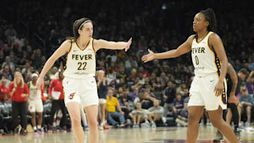 Jun 30, 2024; Phoenix, Ariz., U.S.; Indiana Fever guard Caitlin Clark (22) slaps hands with guard Kelsey Mitchell (0) during the third quarter against the Phoenix Mercury at Footprint Center. Mandatory Credit: Michael Chow-Arizona Republic