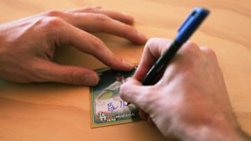 Pitcher Bryan Hudson, acquired last month by the Milwaukee Brewers from the Los Angeles Dodger, signs a card at Topps Spot card signing house in Scottsdale on Feb. 19, 2024.