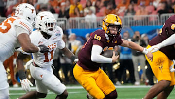 Arizona State quarterback Sam Leavitt (10) scrambles away from Texas linebacker Colin Simmons (11) during the second quarter of the Chick-fil-A Peach Bowl in Atlanta on Wednesday, Jan. 1, 2025.