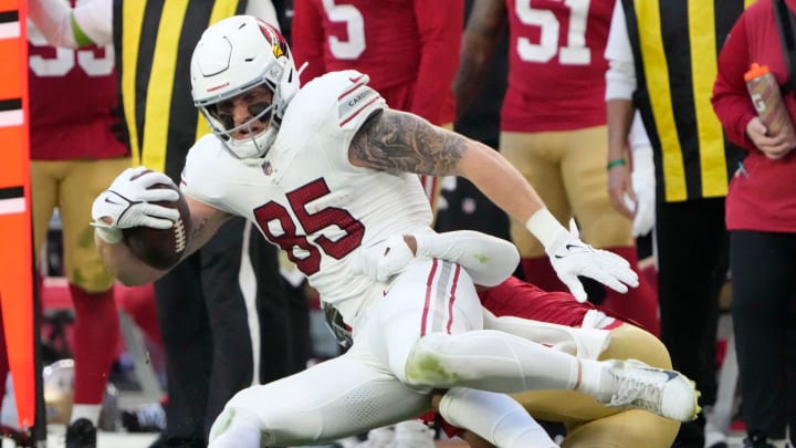 Arizona Cardinals tight end Trey McBride (85) is tackled by San Francisco 49ers cornerback Deommodore Lenoir (2) during the third quarter at State Farm Stadium in Glendale on Dec. 17, 2023.