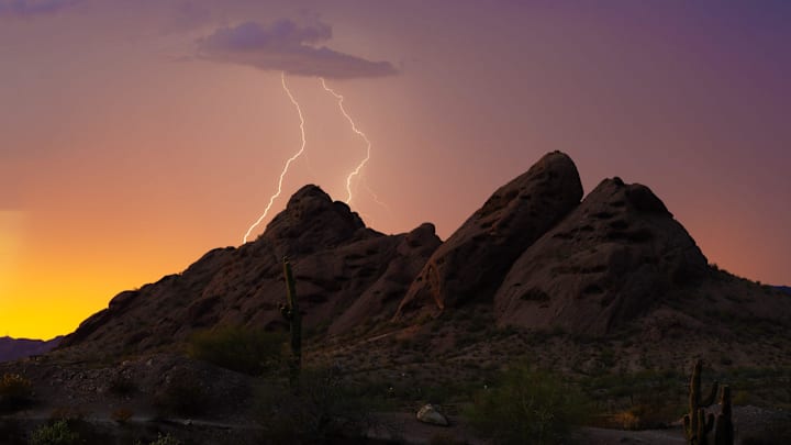 Lightning strikes behind Papago Park in Phoenix during a monsoon thunderstorm on Aug. 8, 2024.