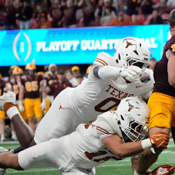Cam Skattebo runs past Texas linebackers at Peach Bowl.