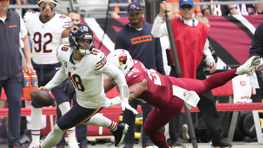 Chicago Bears quarterback Caleb Williams (18) escapes from pressure by Arizona Cardinals linebacker Zaven Collins (25) during the first quarter at State Farm Stadium on Nov 3, 2024, in Glendale. Chicago Bears quarterback Caleb Williams (18) escapes from pressure by Arizona Cardinals linebacker Zaven Collins (25) during the first quarter at State Farm Stadium on Nov 3, 2024, in Glendale.