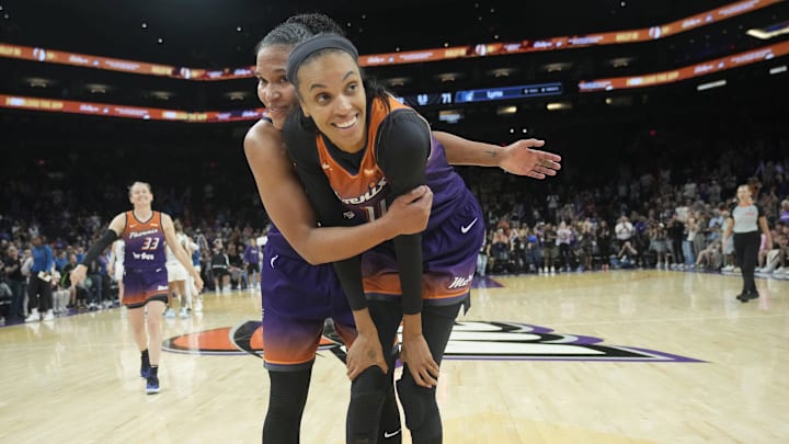 Phoenix Mercury forwards Alyssa Thomas (left) and DeWanna Bonner hug after beating the Minnesota Lynx 79-71 at PHX Arena on July 9, 2025. The teammates are engaged.