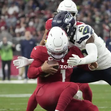 Arizona Cardinals quarterback Kyler Murray (1) is sacked by Seattle Seahawks cornerback Devon Witherspoon (21) during the third quarter at State Farm Stadium in Glendale on Jan. 7, 2024.