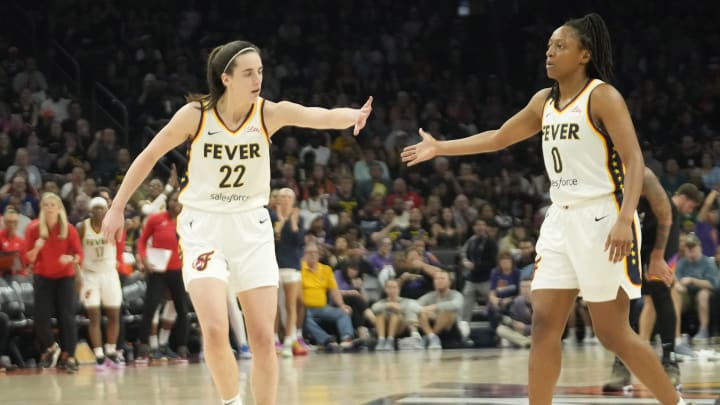 Jun 30, 2024; Phoenix, Ariz., U.S.; Indiana Fever guard Caitlin Clark (22) slaps hands with guard Kelsey Mitchell (0) during the third quarter against the Phoenix Mercury at Footprint Center. Mandatory Credit: Michael Chow-Arizona Republic